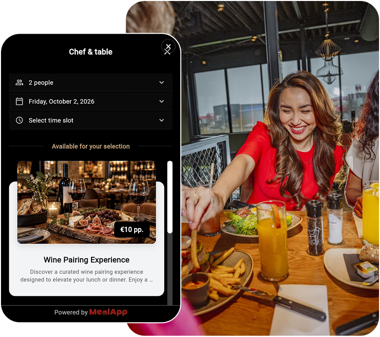 MealApp reservation widget on a phone next to diners at a restaurant table